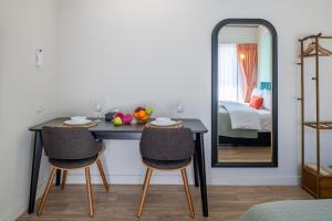 a room with a table and two chairs and a mirror at Boutique hotel Axis Bangkok in Bangkok