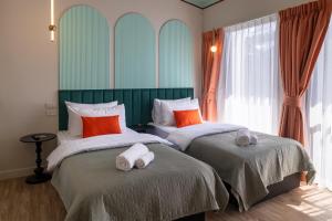 a bedroom with two beds with towels on them at Boutique hotel Axis Bangkok in Bangkok +19 photos
