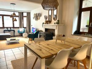 a living room with a wooden table and chairs at Au Fil de boh'Ô in Vresse-sur-Semois