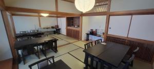 an empty room with tables and chairs in a restaurant at Seifuso At Myoko in Myoko