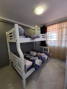 a couple of bunk beds in a room at Unique Homes 1 Bedroom in Karatina