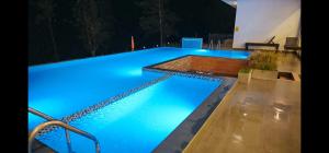 a large swimming pool with blue lights on it at Tea Hills Lake in Hatton