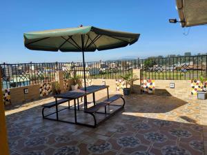 a table with an umbrella on a patio at Unique Homes 1 Bedroom in Karatina
