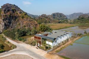 an aerial view of a house next to a river at Ailee Villa&Hotel TamCoc in Ninh Binh