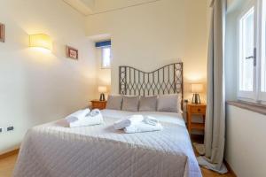 a bedroom with a large bed with towels on it at A green flat in Via della Vigna Nuova in Florence