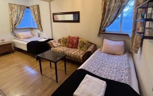 a living room with two beds and a couch at Akureyri Center Rooms in Akureyri
