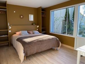 a bedroom with a bed and a large window at Maison M, chambre privée accès jardin piscine et jacuzzi près de La Rochelle in La Rochelle +42 photos
