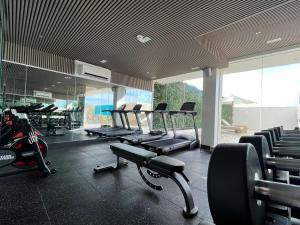 a gym with rows of chairs and a row of machines at Uma Hotel and Residences in Naga