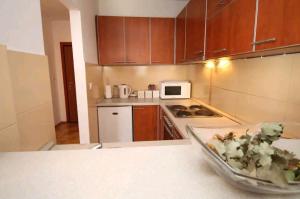 a kitchen with a bowl of food on a counter at Sea & Mountain View Apartment in Budva