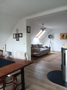 a living room with a couch and a table at Ferienwohnung Engelsthann in Hilders