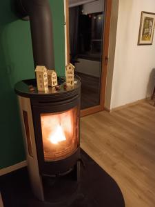 a woodburning stove with a candle in a room at Ferienwohnung Engelsthann in Hilders