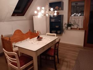 a dining room table with chairs and a chandelier at Ferienwohnung Engelsthann in Hilders +32 photos