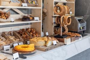 a bakery with bread and other baked goods on display at Rise Urban Art Hotel in Larnaca