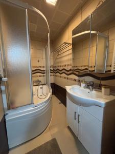 a bathroom with a shower and a sink and a tub at Heavenly Peace Stunning View Terrace Jacuzzi in Istanbul