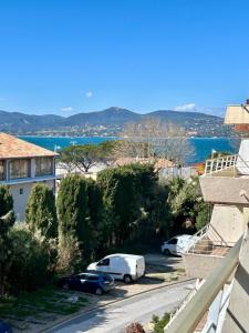 a view from the balcony of a house with cars parked at Studio Eden vue mer in Saint-Tropez