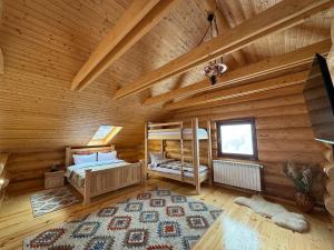 a bedroom with two bunk beds in a log cabin at Cabana Om Bun in Piatra