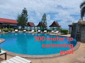 a swimming pool at a resort with the words meter to swimming pool at Archary Lanta Apartment in Ko Lanta