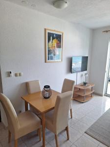 a dining room with a table and chairs at Apartman Fishers View in Trogir