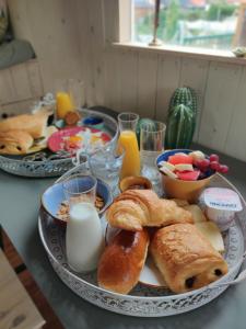 a table topped with a plate of pastries and eggs at Peace in Assenede +1 photo