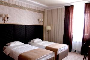 Postel nebo postele na pokoji v ubytování Astor Hotel & Spa
