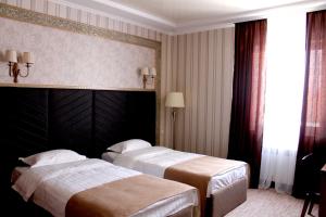 Кровать или кровати в номере Astor Hotel & Spa