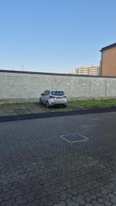 a car parked in a parking lot next to a wall at Baroni B - FREE private parking-wi- fi and A-C in Milan