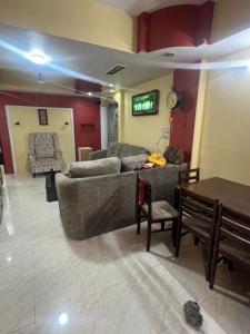 a living room with a couch and a table at 3BHK in Nerul,near DY Patil Stadium & Wonders Park in Navi Mumbai
