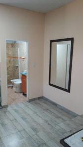 a bathroom with a toilet and a mirror on the wall at Departamento nuevo,amplio y cercano al centro en Posadas in Posadas +7 photos