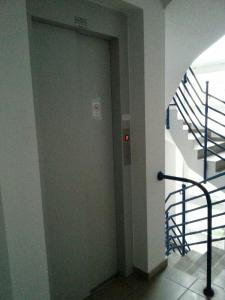 a door in a room with a stair case at Pedestrian Street Apartment in Hévíz