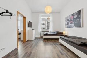 a bedroom with two beds and a living room at KA01 Schicke Wohnung in Worms! in Worms