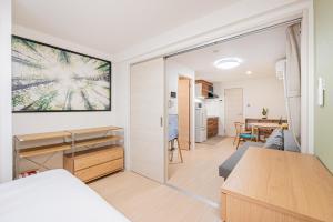 a small apartment with a kitchen and a living room at Float Inn Shin-Okachimachi in Tokyo