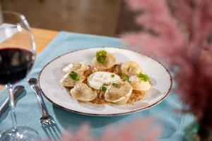 a plate of food with dumplings on a table at Hotel Aqua Sopot - Destigo Hotels in Sopot