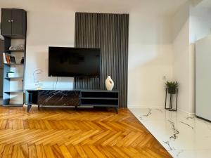a living room with a flat screen tv on a wall at Matija Urban Suits- Downtown in Podgorica
