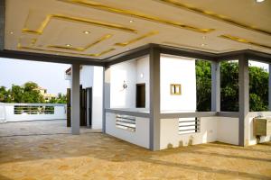an empty house with a ceiling and windows at Spacious Apt with Patio & Rooftop in Cité Baguida in Lomé