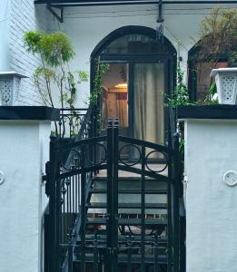 an entrance to a house with a black gate at Chakk 109 Mussoorie Foothills, Dehradun in Dehradun