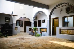 a building with arches and a stone patio at Stylish 2BR Modern Apt in Cité Baguida in Lomé