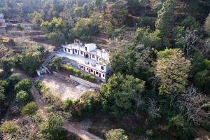 an aerial view of a house in a forest at Sun Shine Haven Retreat in Kasauli