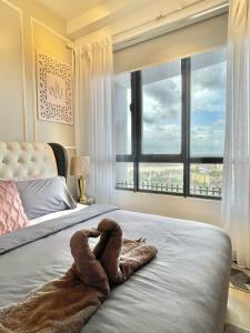 a snake laying on a bed in a bedroom at Nurbaya Suite Troika KB in Kota Bharu +20 photos