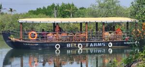 a boat in the water with people on it at Bell Farms and Resorts in Munroe Island