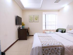 Voodi või voodid majutusasutuse Guangzhou Uhome Service Apartment toas