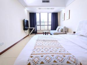 Voodi või voodid majutusasutuse Guangzhou Uhome Service Apartment toas