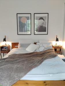 a bedroom with a bed with three pictures on the wall at Cosy oasis with a view in London