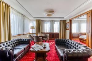 a hotel room with a couch and a table at Haffner Hotel & SPA Sopot - Destigo Hotels in Sopot