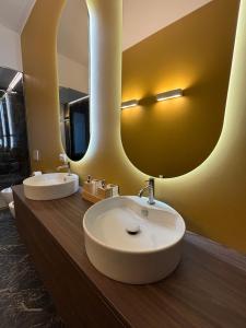 a bathroom with two sinks and two mirrors at settala 10 apartments in Milan