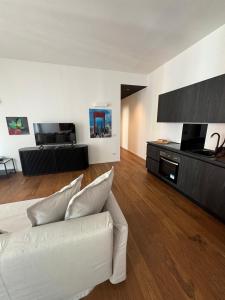 a living room with a white couch and a television at settala 10 apartments in Milan