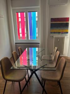 a dining room with a glass table and chairs at settala 10 apartments in Milan