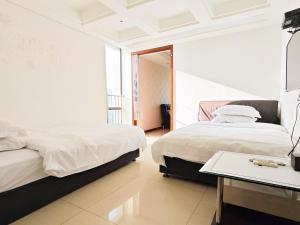 Voodi või voodid majutusasutuse Guangzhou Uhome Service Apartment toas
