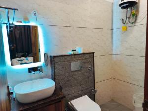 a bathroom with a sink and a toilet and a shower at Hotel Vaidik Ganga in Rishīkesh +99 photos