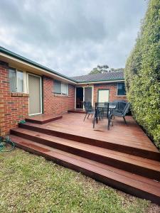 a wooden deck with a table and chairs on it at 250m to the beach! Comfortable and Convenient in Cowes