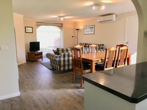 a dining room and living room with a table and chairs at 250m to the beach! Comfortable and Convenient in Cowes